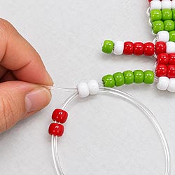 Grinch pony bead keychain pattern showing the cord weaving path through the body and legs.